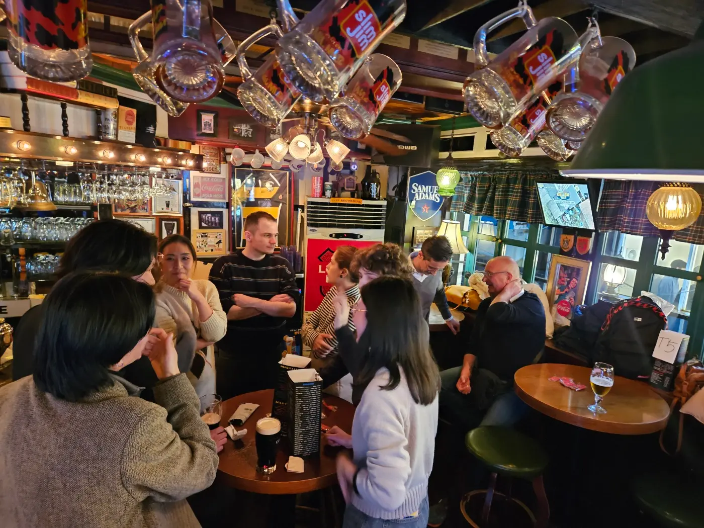 Group of people standing in a pub during an event organized by the Belgian Korean Business Forum, BKBF